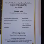 A printed program lists the 2026 Hall of Fame Induction ceremony agenda for the Women's Club at University of Central Florida, including speakers and committee members.